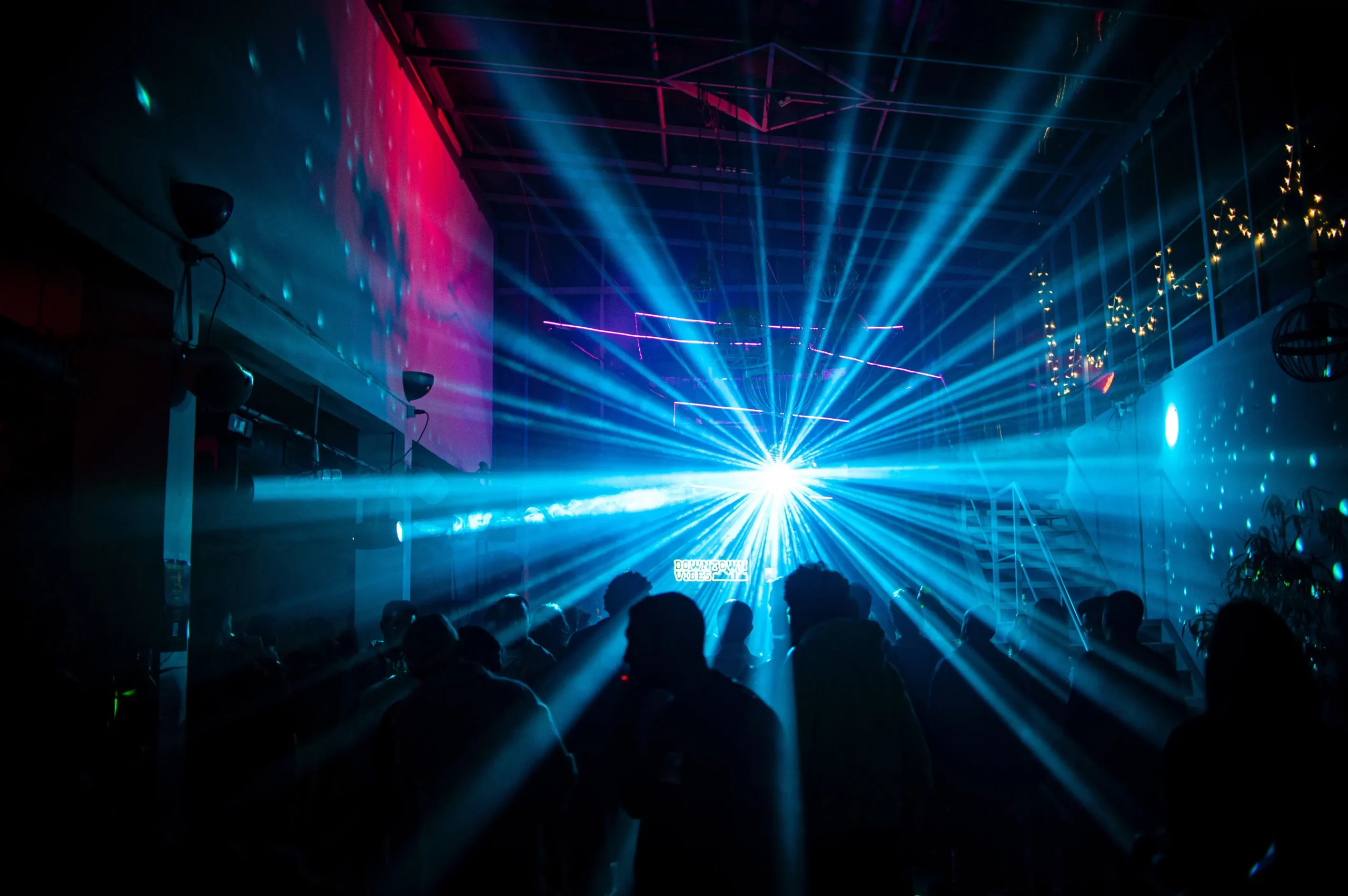 laser light show at a night club with a crowd enjoying the music and atmosphere