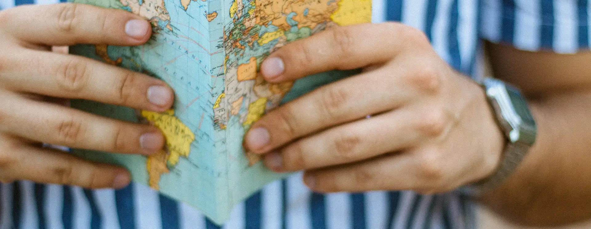 a person holding a map of the world