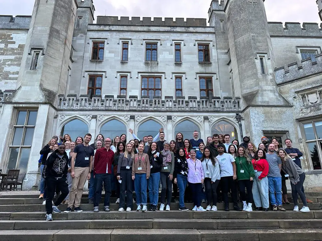 group of people standing in front of historic building