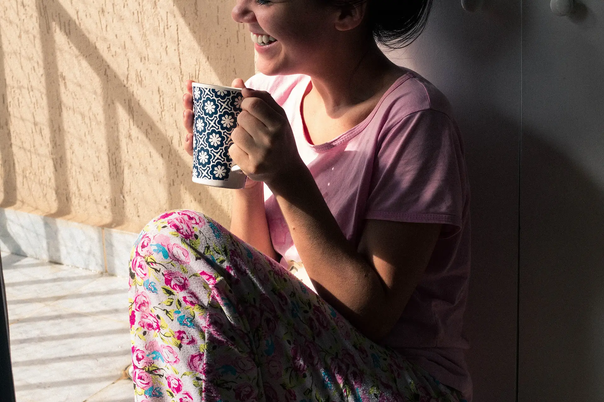 woman holding mug and smiling